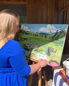 Jacqui Brown painting in her studio, working on a landscape artwork inspired by the Southern Highlands, featured in Seven Seasons exhibition Bowral