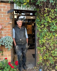 Ceramic artist Peter Schmid of Hillside Pottery standing in his studio in the Southern Highlands NSW