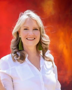 Sarah Norton Creative portrait with vibrant red abstract artwork background, Southern Highlands artist