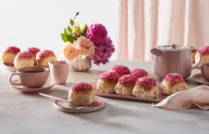 Bakers Delight Fun Buns with pink icing served with tea and flowers for the BCNA breast cancer fundraising campaign.