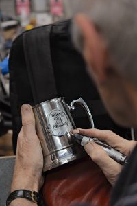 Engraving a keepsake mug at Mr Fixit in Bowral.